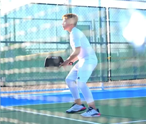 Jett in ready position at the kitchen wearing Babolat Propulse Fury 3 shoes